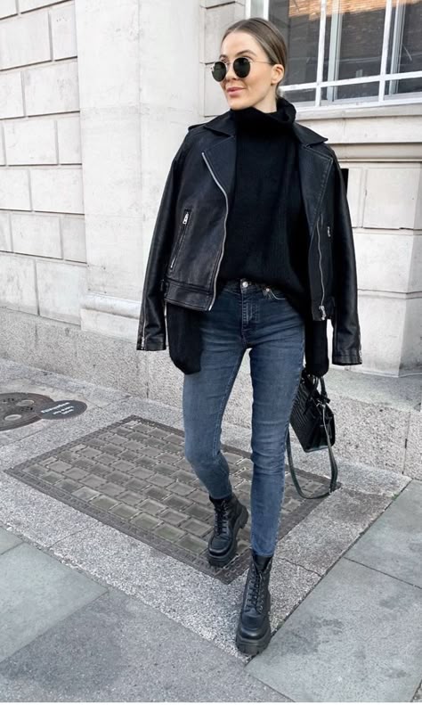 Stylish woman wearing a cropped leather jacket paired with high-waist pants for a chic modern look.
