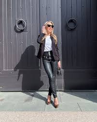 Stylish woman wearing black leather pants paired with a blazer and heels for a chic look.